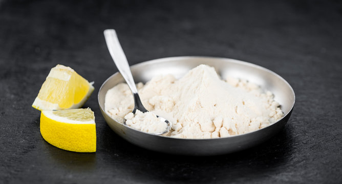 Portion of fresh Lemon powder (selective focus; close-up shot)