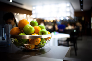 Vase with juicy fruits. Style hi-tech. Whole fruit. Oranges and apples.