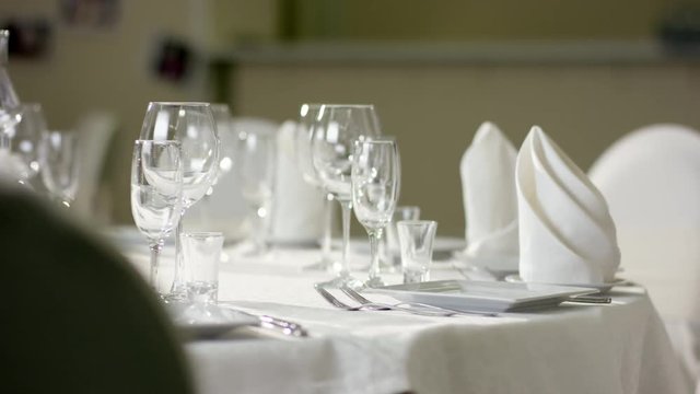 Waiter hand making dinner table looks better before event at luxury restaurant