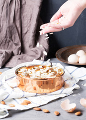 Pear cake with almond paste, vertical, selective focus, hands in frame