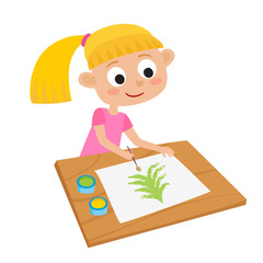 Little girl artist at a table and painting Chrismas tree.