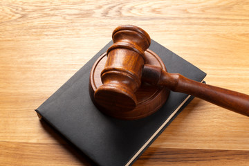 Gavel and legal book on wooden table