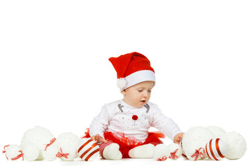 Beautiful funny baby in a Christmas hat isolated on white