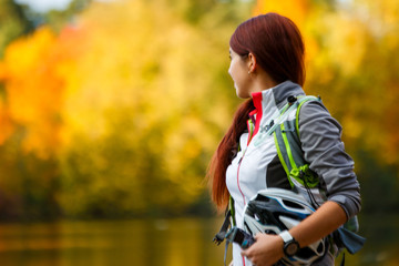 Fototapeta premium Photo of woman with backpack and bicycle helmet
