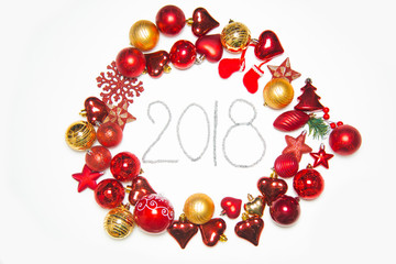 Top view on frame made of christmas decoration with new year balls on isolated white background with inscription 2018