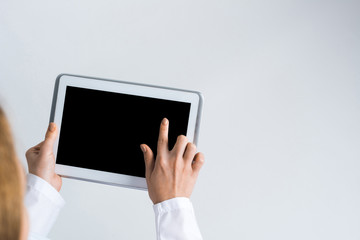 Close of female doctor hands working with tablet pc computer