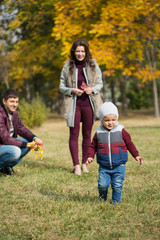 Fototapeta premium family walks in the autumn park