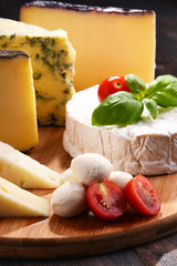 Different sorts of cheese on kitchen table