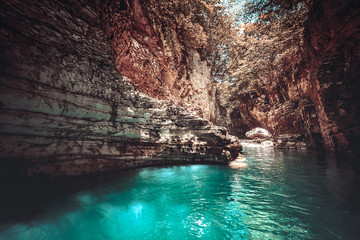 Martvili canyon in Georgia. Beautiful canyon with blue water mountain river. Place to visit. Nature landscape. Travel background. Holiday, rafting, sport, recreation. Vintage retro toning filter