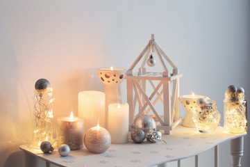 home Christmas decoration with candles on background  white wall