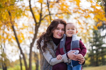 Fototapeta premium mother with her son walks in the autumn park