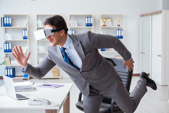 Businessman exercising in office wearing VR glasses