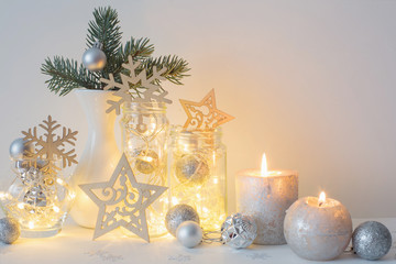 Christmas decoration with candles on background  white wall
