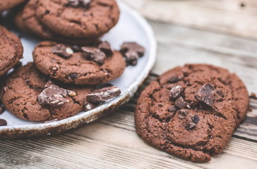 Oatmeal cookies with chocolate pieces on a wooden background