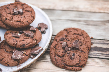 Oatmeal cookies with chocolate pieces on a wooden background