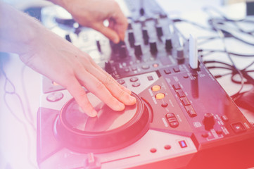 DJ console in the club stage light, hands control