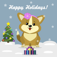 Christmas card with a cute dog Corgi with a flower on his head, sitting next to a decorated Christmas tree and a gift box against the background of snowflakes.