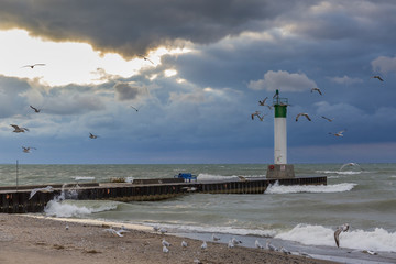 Lighthouse and pier on Lake Huron under a stormy sky - Ontario, Canada
