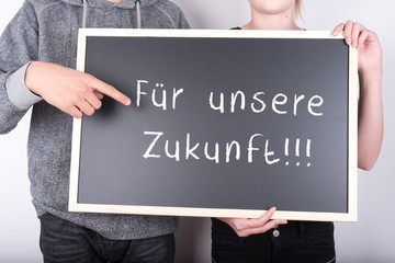 Kinder zeigen Schild mit Zukunft