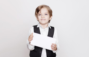 Happy young blond boy holding blank for poster in hands isolated on white background.