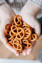 Woman holding hip of pretzel or bretzel in hands