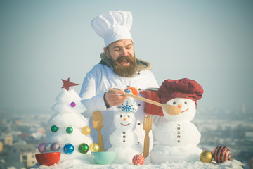 Happy hipster in chef hat and uniform on winter day