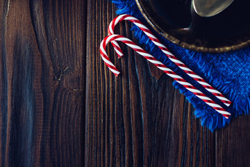 Top view of christmas candy canes on the wooden background.