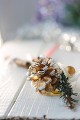 Obraz na płótnie Canvas White christmas decoration - pinecone on wooden board.