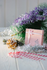 Box with new year gifts and presents on white wooden board.