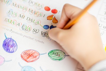first year in elementary school / young boy is doing his homework in writing