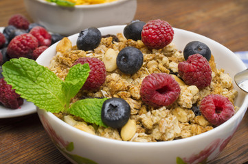 fresh muesli withwith raspberries, blueberries close-up