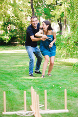 Fototapeta premium Friends plaing outdoor games - ring toss.