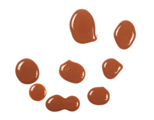 Spilled chocolate milk puddle isolated on white background, top view