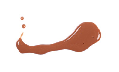 Spilled chocolate milk puddle isolated on white background, top view