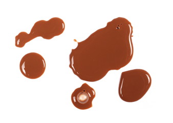 Spilled chocolate milk puddle isolated on white background, top view