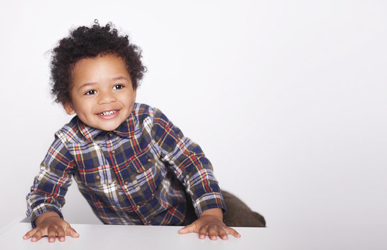 Portrait Of A Cute Smiling African American Little Boy In Checkered Shirt  Isolated On White Background.