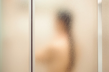 Sensual portrait of young woman taking a shower. Body and skin hygiene