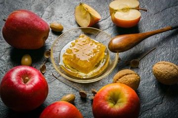 Homemade nice background of autumn apples, honey and walnuts. Black stone background. View from above. place for text.