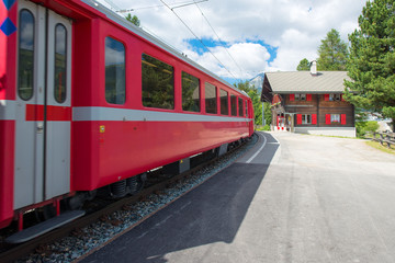 Obraz premium Staz station in Celerina Switzerland with the red train of the Rhaetian Alps