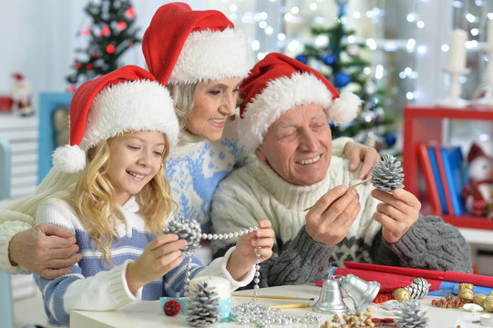 girl with grandparents preparing for Christmas