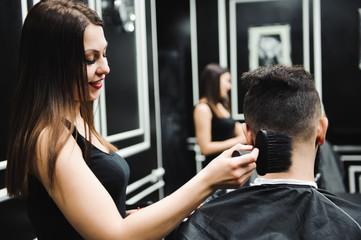 Master cuts hair and beard of men in the barbershop, hairdresser makes hairstyle for a young man