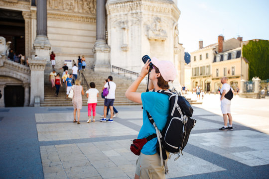 Bergamo Italy girl backpacker standing with backshot photo temple attractions behind a black backpack