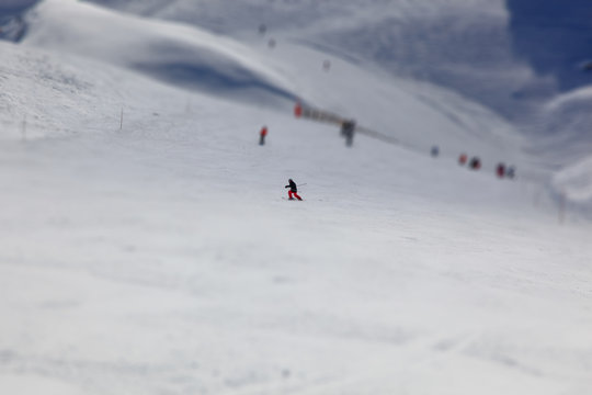 Child skiing in mountains.
Blurry background.