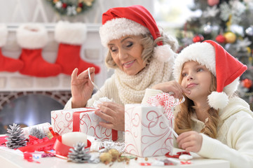 Grandmother and granddaughter preparing for Christmas