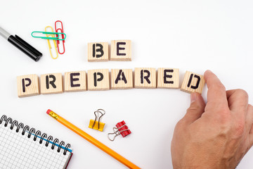 be prepared. Wooden letters on a white background.