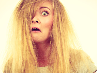 Crazy, mad blonde woman with messy hair