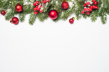 Naklejka na ściany i meble Christmas background on white. Snow fir tree red balls and decorations.