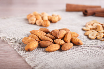  cinnamon, almonds, hazelnuts, cashew on a linen napkin.