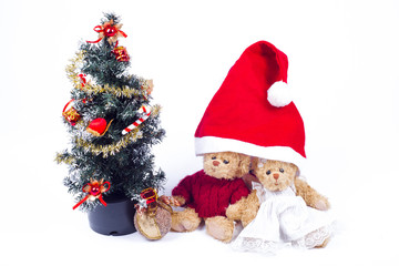 Obraz na płótnie Canvas Plush bear cubs near an artificial Christmas tree with Santa Claus. imitation of the family under the hood