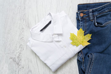 White shirt, jeans and a maple leaf. Fashionable concept